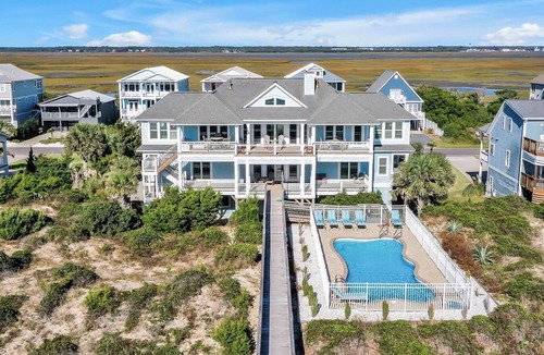 Caswell Beach House | Experience oceanfront luxury at 'Our American Dream' in Oak Island, NC, perfect for 19 guests!