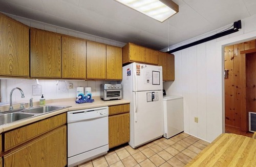 Greenville Junction House | Lakefront Home with Private Dock, Pebble Beach & Enclosed Porch - Dogs Welcome