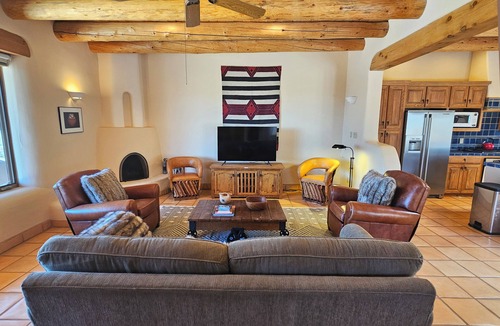 Arroyo Seco House | Sweeping panoramic mountain views, expansive adobe privacy wall system