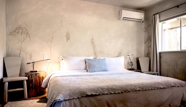 Enjoy our designer King Suite, nestled among the pines with premium linens, a deep soaking tub and lush gardens Experience the sunrise or sunset on the front patio in our wooden rocking chairs Close to Vineyards for Wine lovers 9 miles from