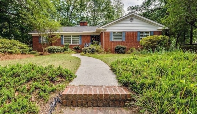 Large charming 4 bedroom, 3 bath on quiet wooded lot with lots of space for all!