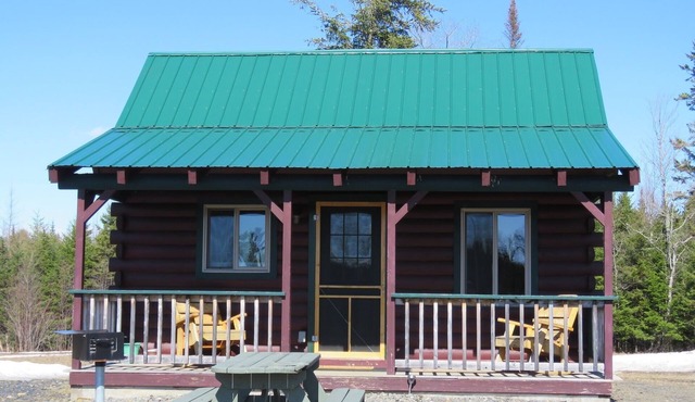 Modern log cabin with pond view available for rent in middle Maine.
