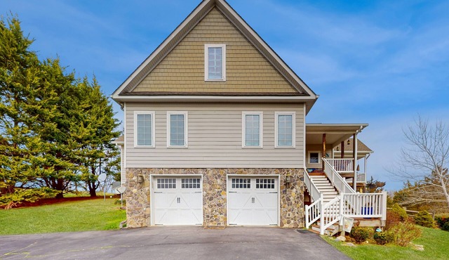 Nature lover's lakefront home with a beach, dock, fire ring, & more