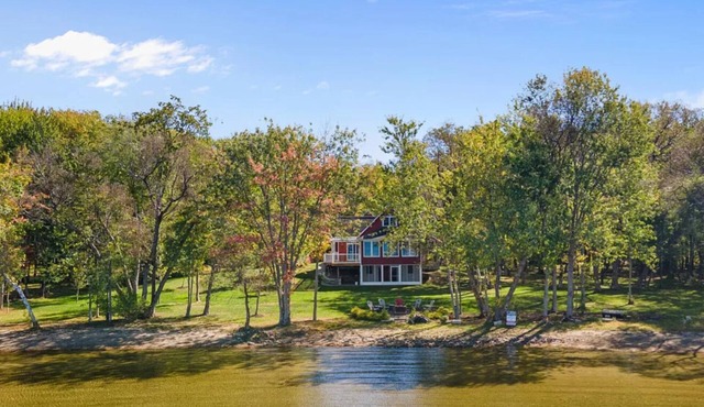 Stunning Lakefront Retreat set on a Private point on North Pond, 9 acres w/beach